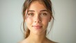 © MP_Artworks - A young woman with flawless, smooth skin, gently smiling at the camera. Her skin is radiant, without visible imperfections. Perfect for content related to skincare and beauty.