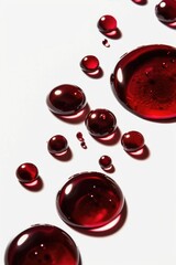 Poster - A close-up view of a single red liquid droplet sitting on a white surface