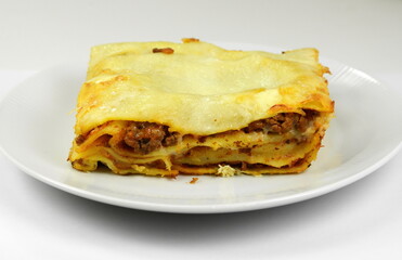 Wall Mural - Portion of tasty lasagna, isolated on white