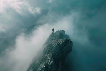 Poster - A person stands at the top of a mountain on a cloudy day, surrounded by misty peaks and atmospheric fog