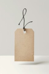 Poster - A simple brown price tag hanging from a string, often used for labeling or pricing items