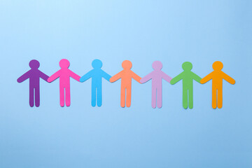 Wall Mural - Equality concept. Different human figures on light blue background, flat lay