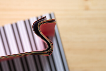 Sticker - wavy paper edge on striped paper and wood (aerial or top-down view)