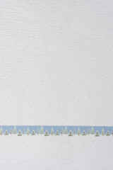 Wall Mural - white crepe paper with crinkled surface texture and holiday ribbon with trees