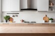 © Ayahe Stock - blurred Sleek cabinets and stainless steel appliances define a modern kitchen interior with empty tabletop