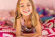 © Austockphoto - young blonde girl resting on her bed with crocheted blanket