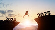 © metamorworks - Businessman jumping from 2024 to 2025. 2025 New Year concept.