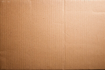 Poster - Close-up of a textured cardboard box surface showcasing the natural fibers and horizontal ridges, ideal for packaging, shipping, and storage-related themes.