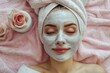 © Ольга Лукьяненко - Beautician applying facial mask to the young lady, towel on head, beauty photo concept, skin care, spa concept