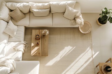 Poster - A white sectional sofa sits on a beige rug in a living room. A wooden coffee table and a wicker side table add a natural touch