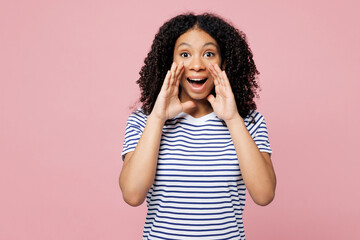 Wall Mural - Little kid teen girl wears blue striped t-shirt casual clothes scream sharing hot news about sales discount with hands near mouth isolated on plain light pink background. Childhood lifestyle concept.