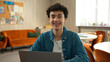 © Yuliia - Caucasian concentrated man male student guy boy schoolboy pupil typing prepare exam online internet school university cafe studying learning education laptop computer e-learning smiling toothy braces