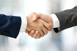 © Tasnim - Close-up of two businesspeople shaking hands, symbolizing agreement, partnership, and trust in a professional setting.