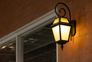 Wall Mural - A lamp hanging from a brick wall