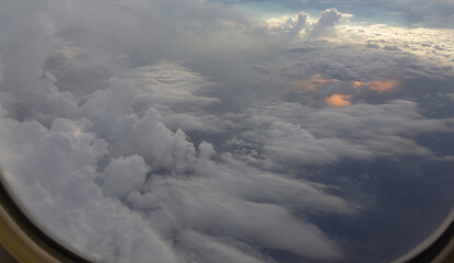 Wall Mural - the sky is filled with clouds and the sun is shining through them. thunderstorm from airplane window