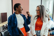 © (JLco) Julia Amaral - Creative colleagues laughing in a vibrant and colorful workplace