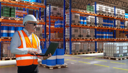 Poster - Man warehouse manager. Owner of logistics company. Warehouse manager stands with laptop in his hands. Man in hangar with high storage racks. Fuel warehouse. Supervisor in storage area