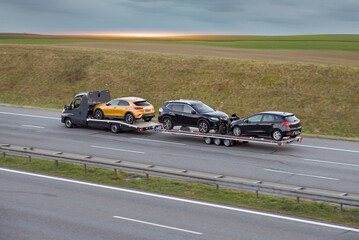 Wall Mural - Flatbed Truck Transporting SUV Hatchbacks And Motorcycle