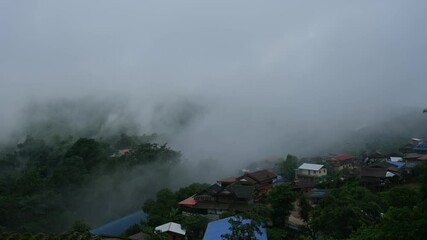 Wall Mural - Rural village in the valley on foggy day