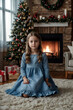 © Alex Vog - Portrait of child cover girl in blue dress posing at Christmas tree and wigwam, thinking looking away. Face of pensive kid girl 7 year old in children room. Christmas magic concept. Copy ad text space