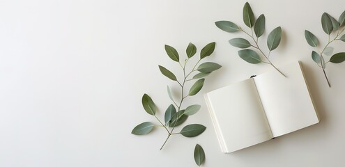 Wall Mural - An open notebook with several flower branches on a white background