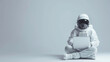 © art-mix - Astronaut using laptop sitting on light gray studio background with copy space, concept of internet technology