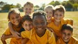 © Oulaphone - Happy children making sport. Group of happy boys making sports huddle. Kids smiling at the camera on an outdoor field.