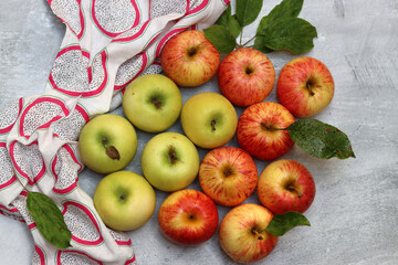 Canvas Print - Beautiful green and red apples top view photo. Juicy organic fruit on light grey textured background with space for text. Healthy eating concept. 