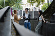 © amnaj - Three youths engage in a spirited discussion outdoors, savoring each other's company during a study break