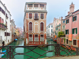 Wall Mural - Typical Venetian canal with bridge in early morning, Venice, Italy