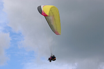 Poster - Tandem Paraglider flying in a cloudy sky	