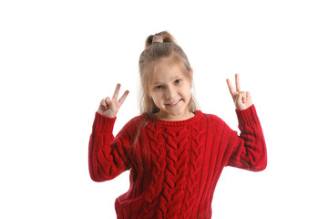 Poster - Cute little girl in knitted sweater showing victory gesture on white background