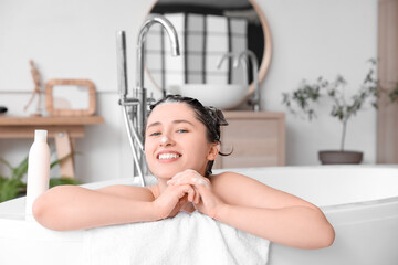 Canvas Print - Beautiful young happy woman with shampoo on hair in bathroom