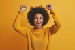© Ольга Лукьяненко - Feeling Ecstatic, A Happy Young Woman with Raised Fists on a solid color Background