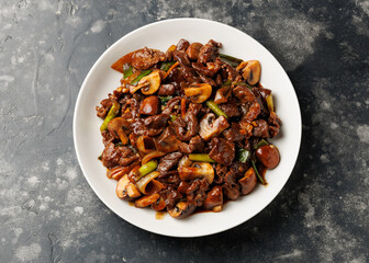 Wall Mural - Beef Mushroom Stir Fry with ginger and garlic in a white plate