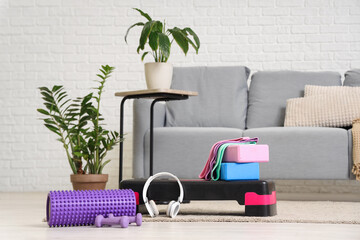 Poster - Sports equipment with headphones on carpet in living room interior