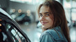 © Pawina - a happy, young, casually dressed, university woman having a close look at her car, in a car showroom.generative ai