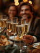 © EzequielOjedafoto - A man and woman are sitting at a table with glasses of champagne