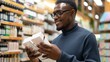 © Oksana - A dark-skinned guy is choosing skincare products in a store. Skincare concept.