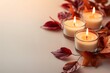 © Lazylizard - Cozy arrangement of lit candles surrounded by red and orange autumn leaves on a soft background, creating a warm and inviting atmosphere..