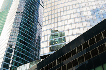 Poster - A tall building with many windows and a cloudy sky in the background