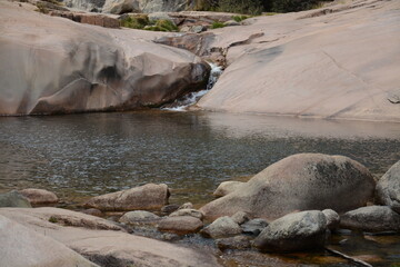 transparent lake in the middle of the rocks in la pedriza in madrid spain