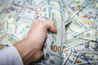 © Kostia - A Dollars in the hands of a businessman man guy for a trip to the rest of the shops