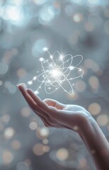 Wall Mural - hand holding glowing atom. physics, science, quantum mechanics, nuclear energy and power concept.