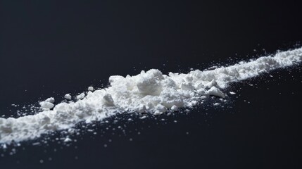 Poster - A close-up shot of a pile of white powder sitting on a black surface