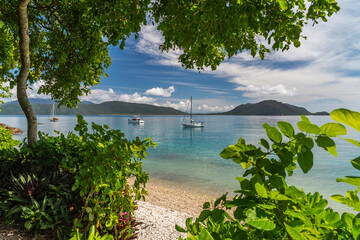 Picturesque tropical coral beach with turquoise water on Fitzroy Island. It is a continental island southeast of Cairns, Queensland, Australia.