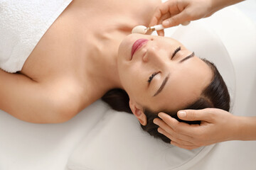 Poster - Young woman having facial massage in spa salon