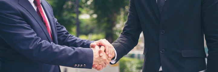 Wall Mural - Banner Lawyer teamwork partnership Businessman handshake together. Panorama Two Men Trust honesty lawfirm business handshake promise respect partner. Diversity solidarity team Partner hands together