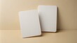 © Caitlin - Minimalist card mockup featuring two blank white cards with rounded corners held against a clean, neutral-colored background.