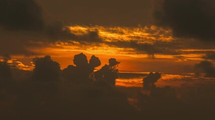 Wall Mural - time lapse of dramatic sunrise with orange sky in a cloudy day.